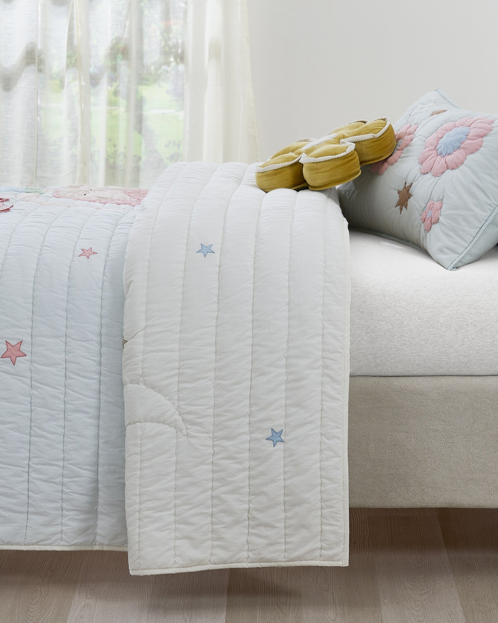 Starry Dance kids AC quilt styled in a bedroom