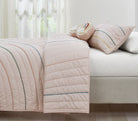 Hush Rainbow kids AC quilt styled in a bedroom
