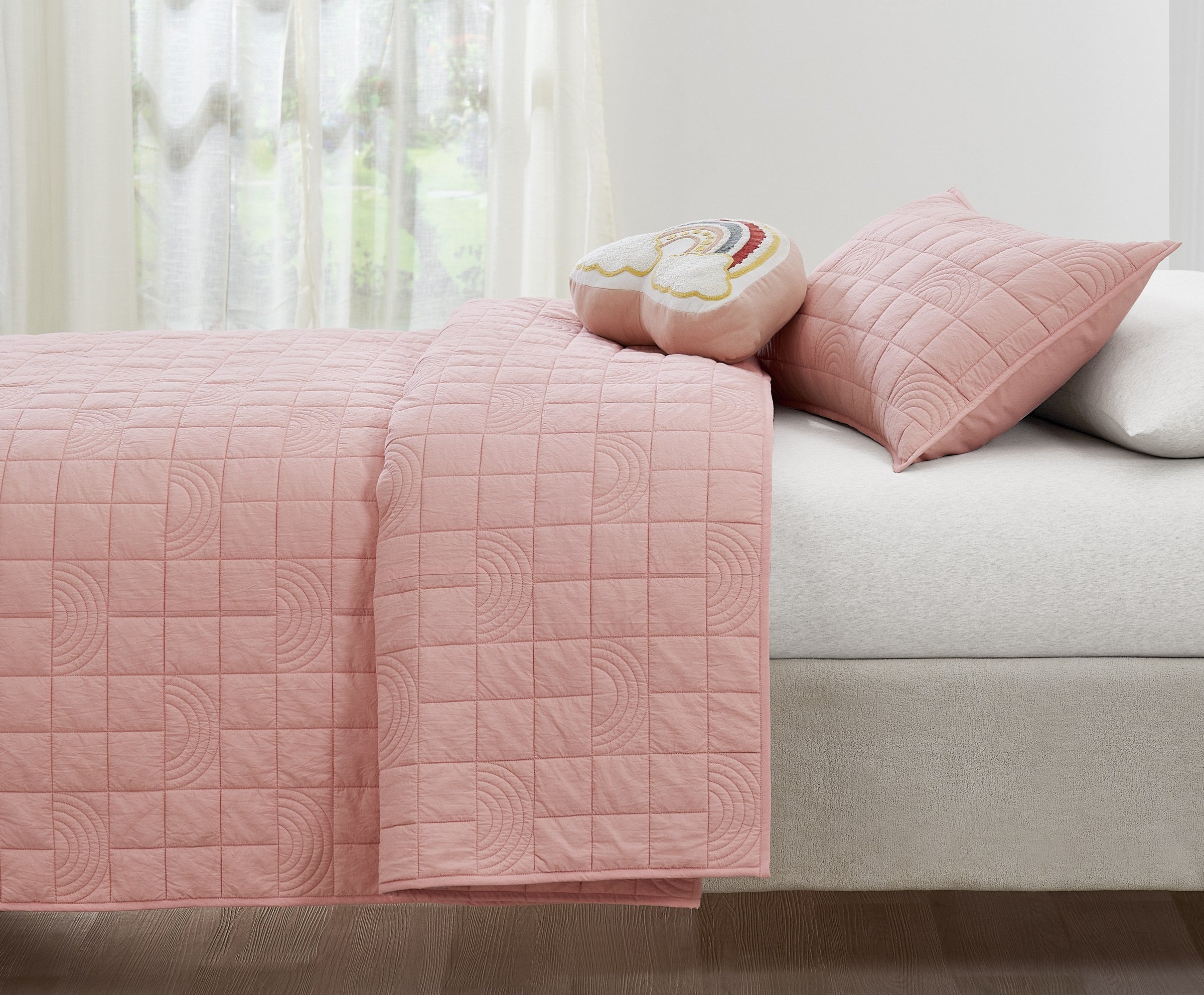 Pink Rainbow kids AC quilt styled in a bedroom
