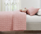 Pink Rainbow kids AC quilt styled in a bedroom