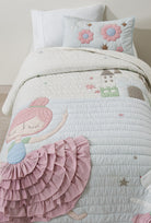 Starry Dance kids AC quilt on a bed