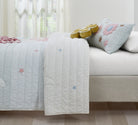Starry Dance kids AC quilt styled in a bedroom
